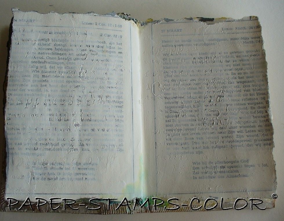 Apply gesso over the pages and stamp in it with a script. Leave to dry.