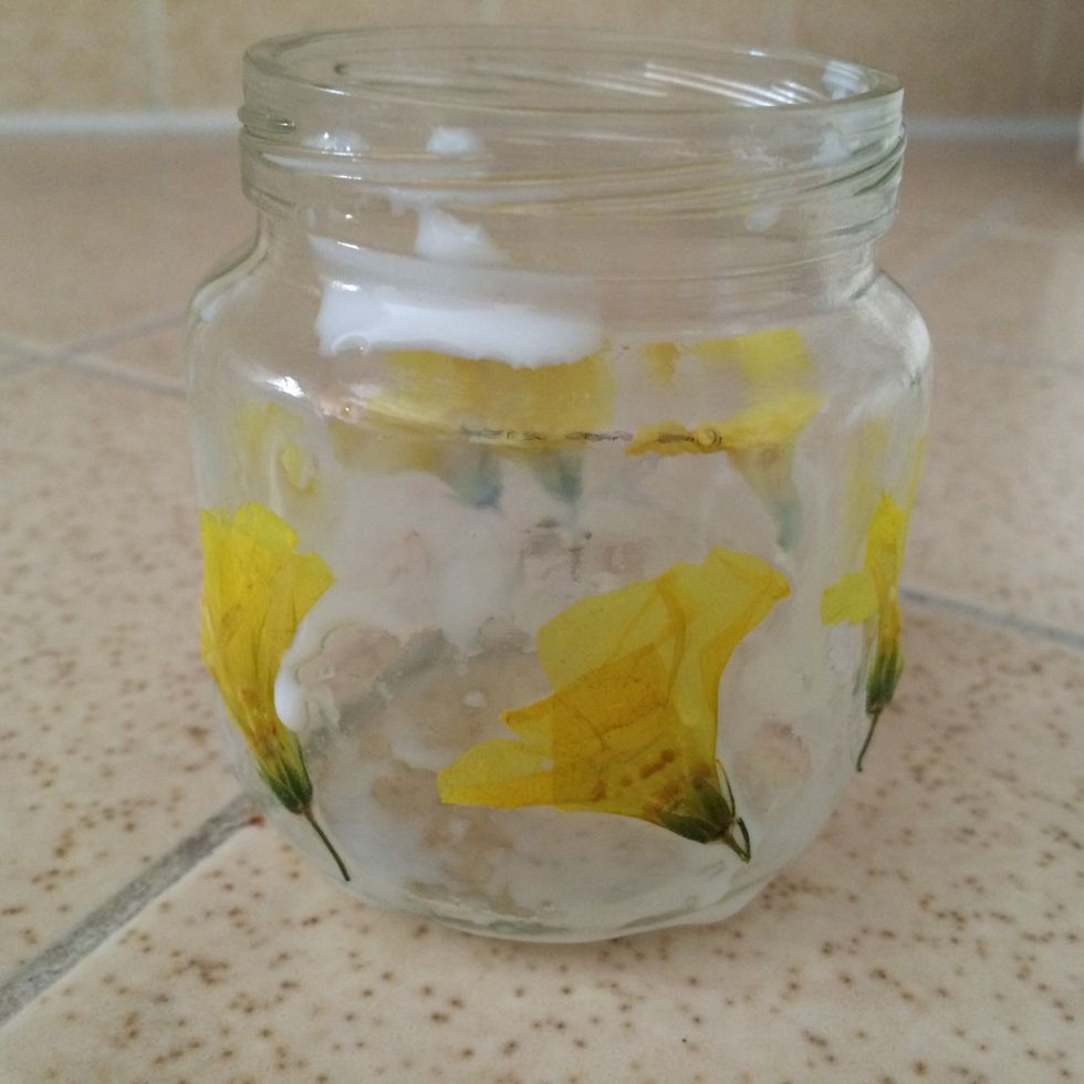 Apply glue mix all over the outside of the jar. Next arrange your flowers on the exterior of the jar. Allow 1-2 minutes to dry.