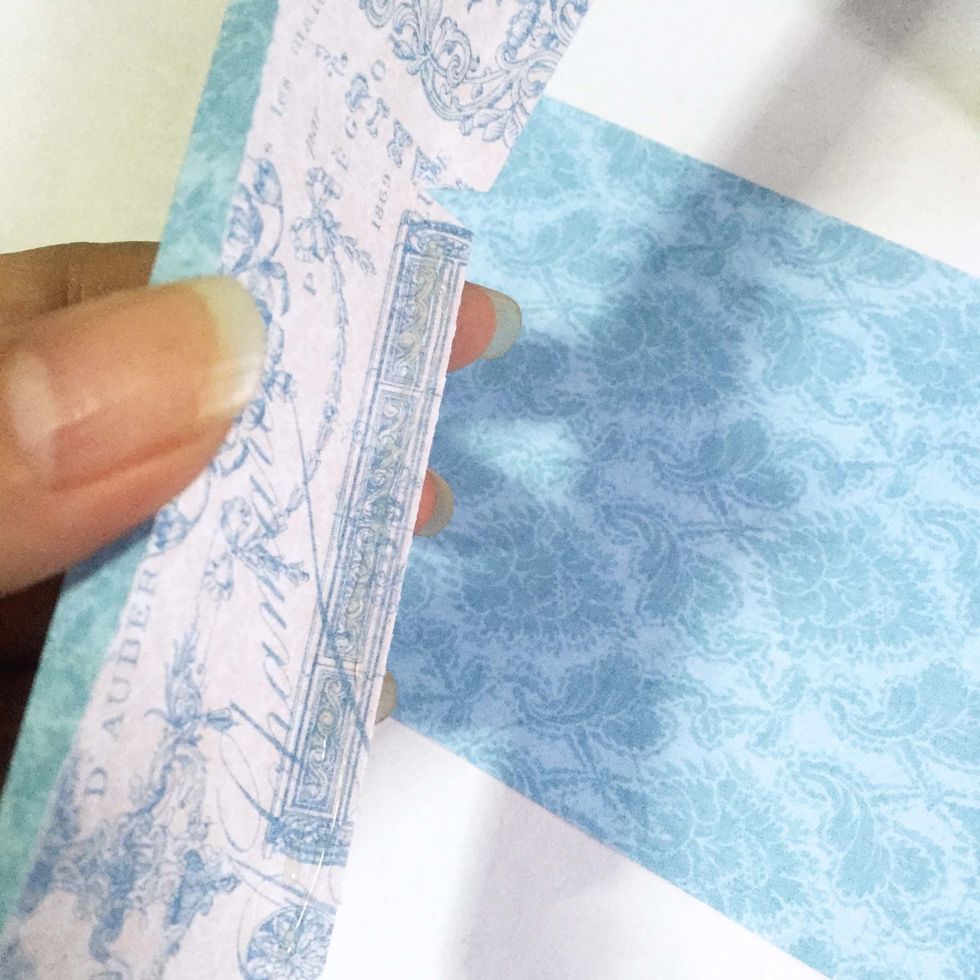 Apply glue on the center tab of the U-shape structure (from Step 23) as shown.
