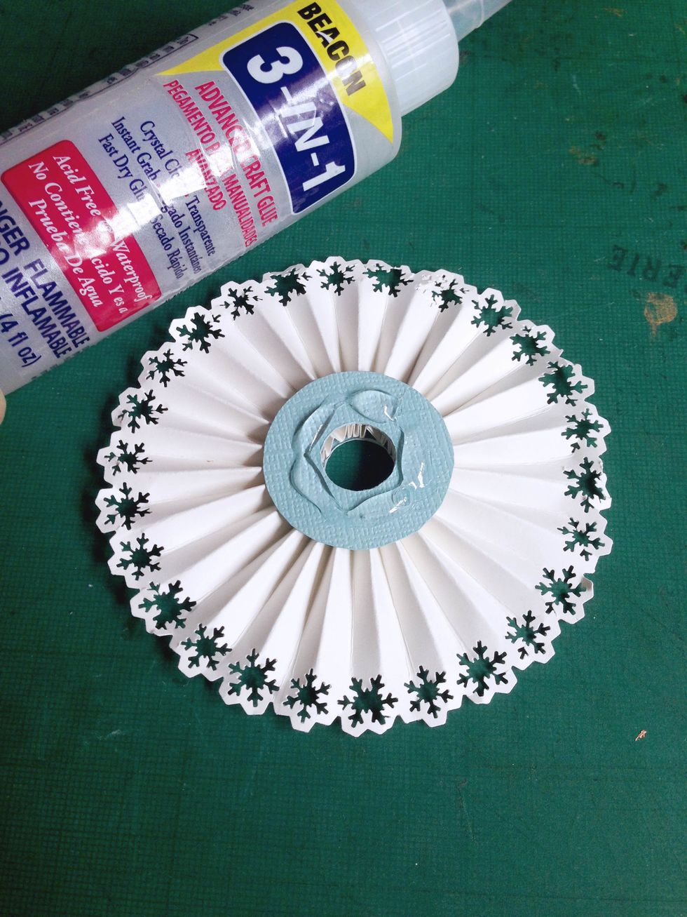 Apply glue on top of the circle as shown...