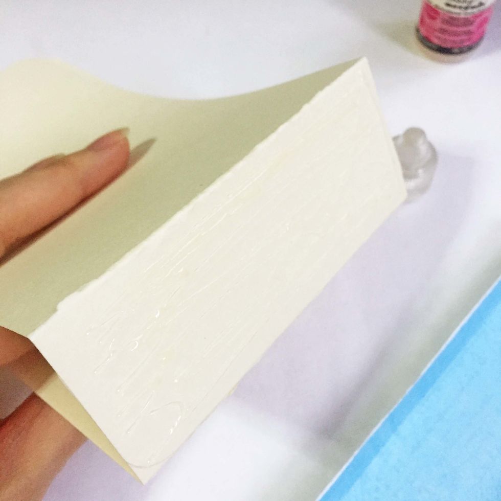 Apply glue onto the base of the tags.