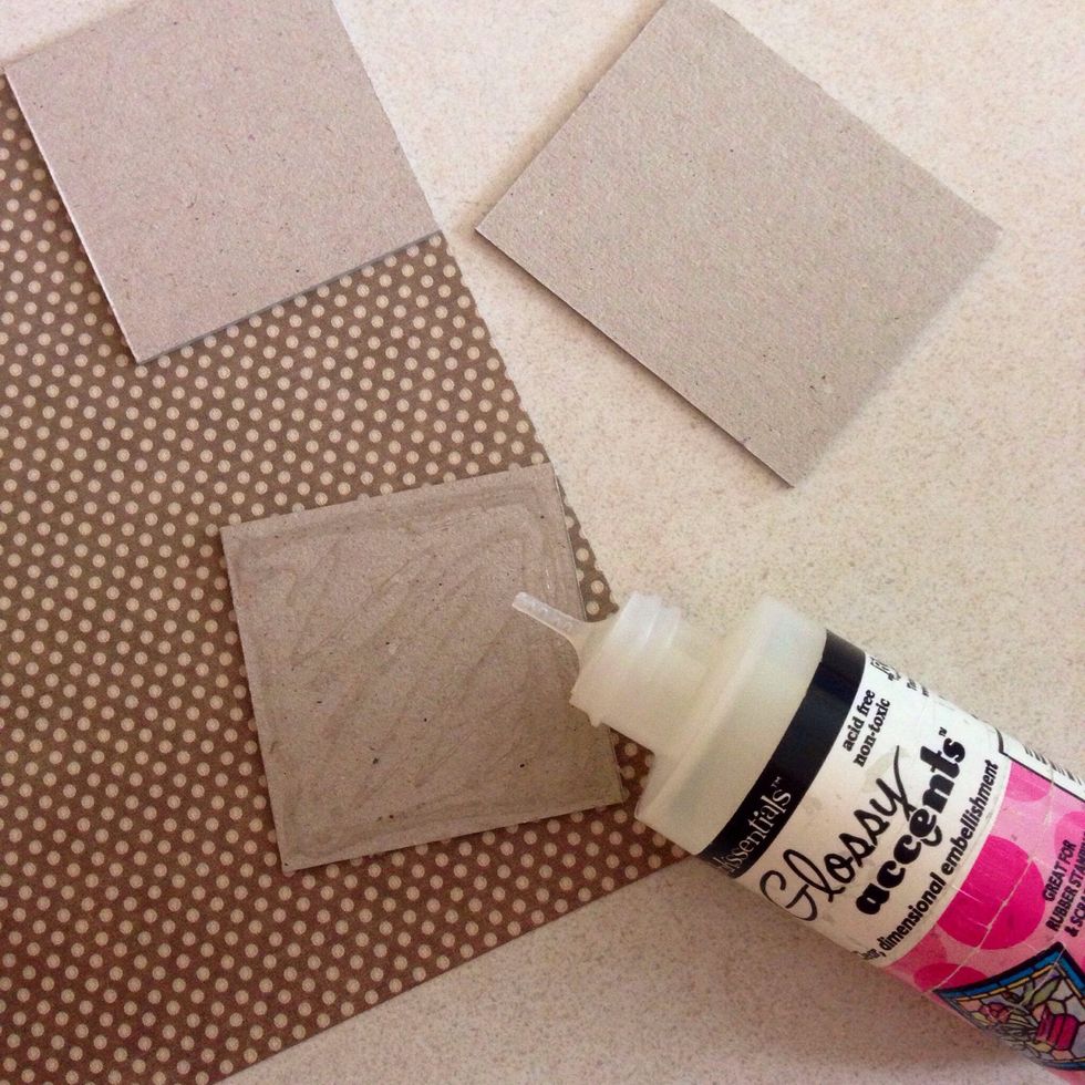 Apply glue or glossy accent onto one surface of the chipboard...