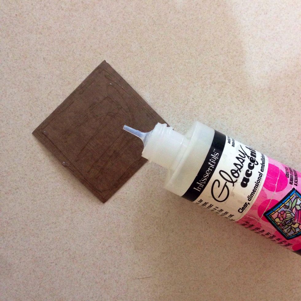 Apply glue or glossy accent onto the wrong side of the pattern paper...