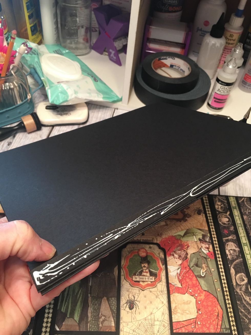 Apply glue or scor-tape to the one remaining hinge of the page set.