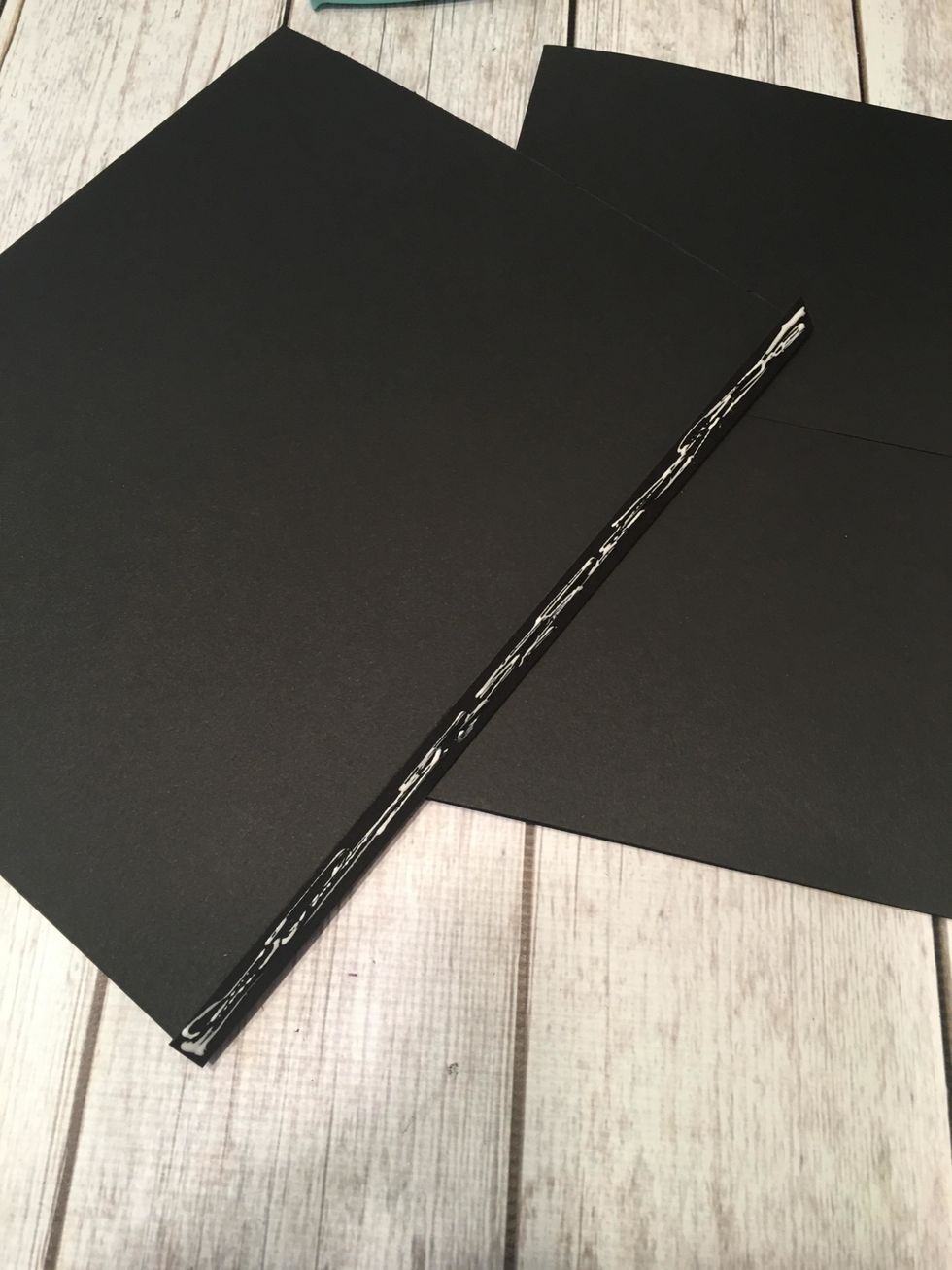 Apply glue or tape to the 1/2" hinge of another full page.