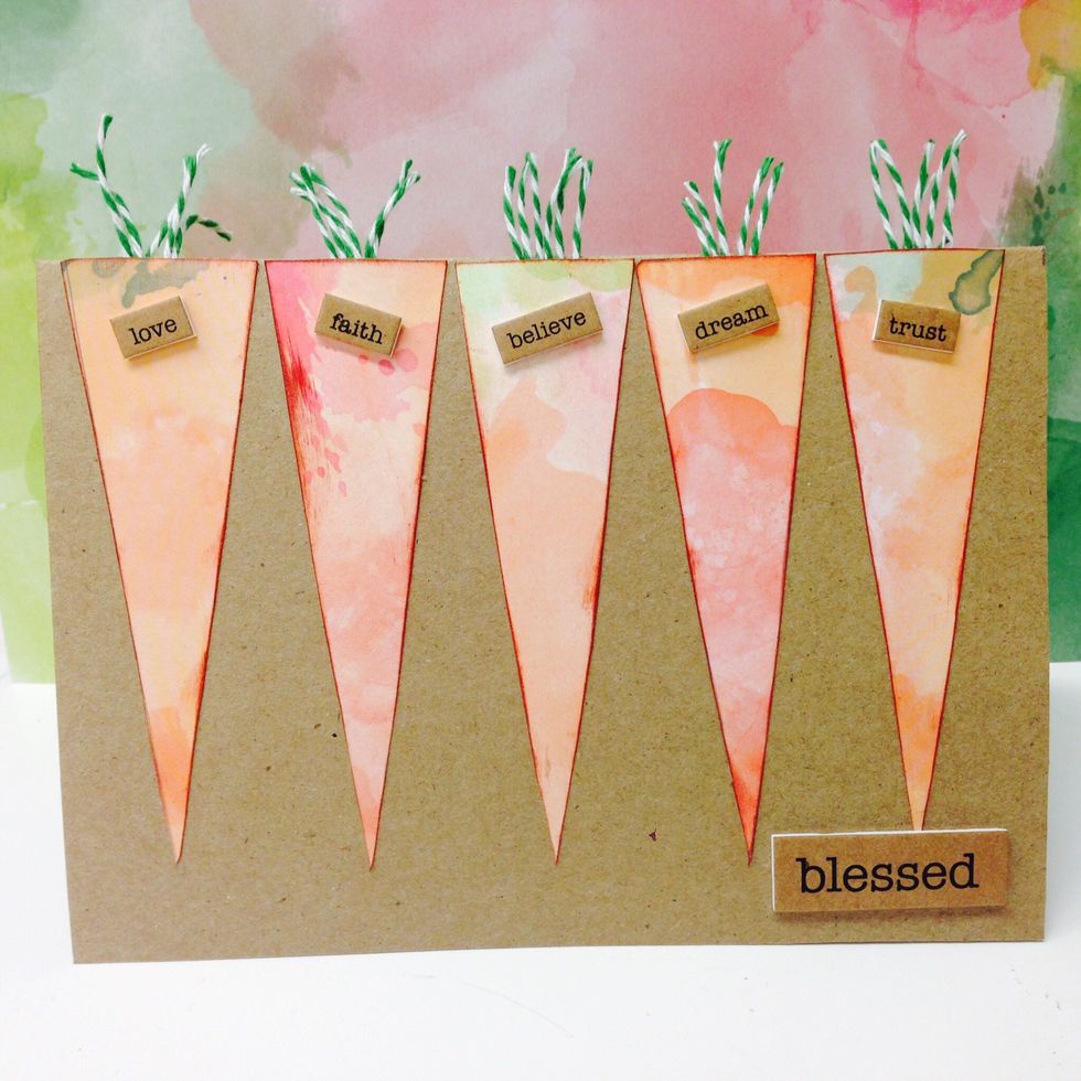 Apply glue stick to the back of each carrot and press into place on the card. Choose a small word sticker to embellish each carrot and one large word sticker for the bottom of the card.