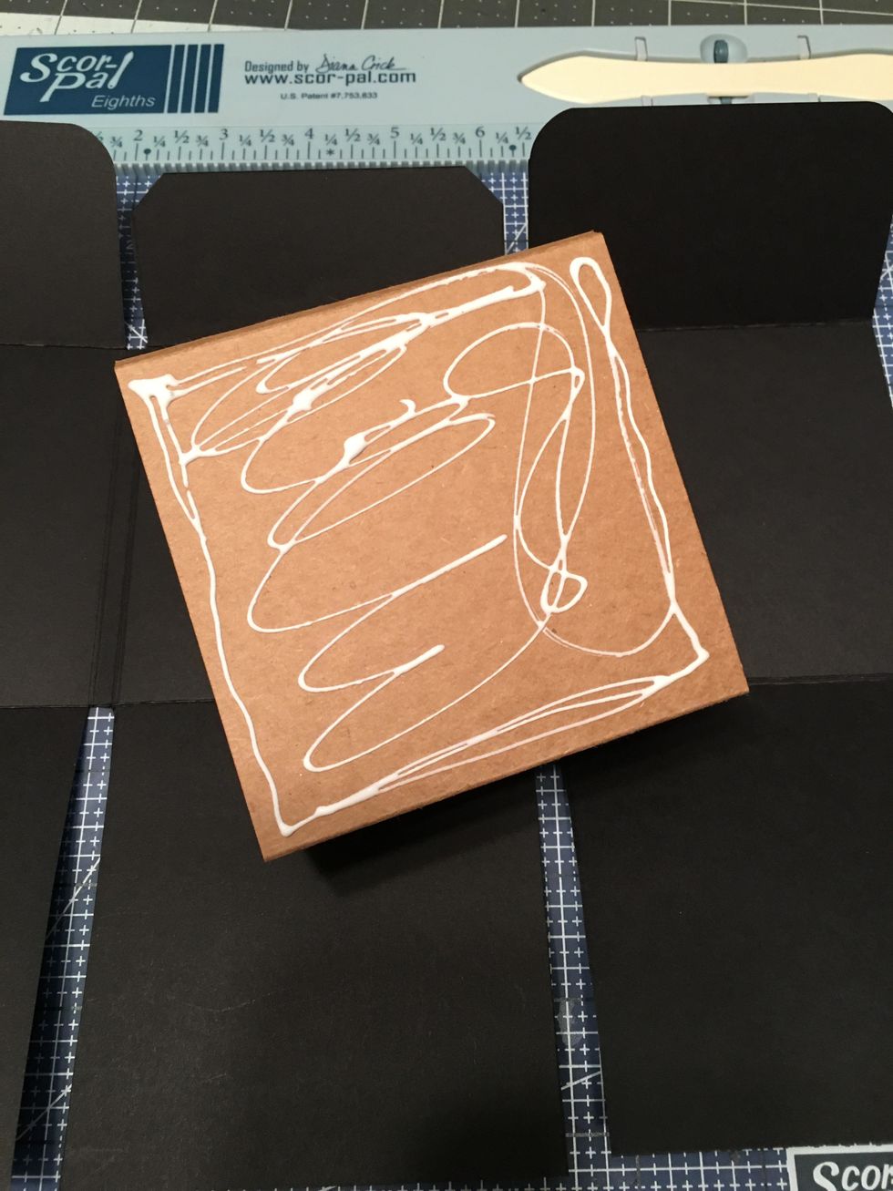 Apply glue to the back center of the tag.