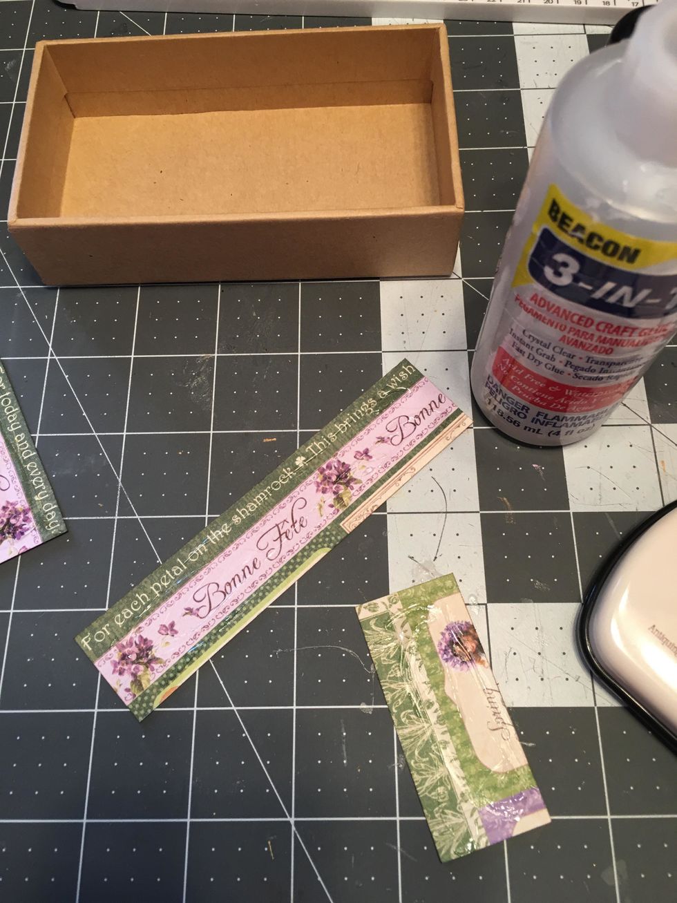 Apply glue to the back side of each paper section and glue to the sides of the box on the inside. (See next photo.)