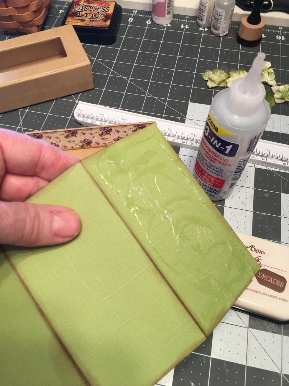 Apply glue to the BACK side of the fold out piece and attach inside to the bottom of the box. (See next photo.)