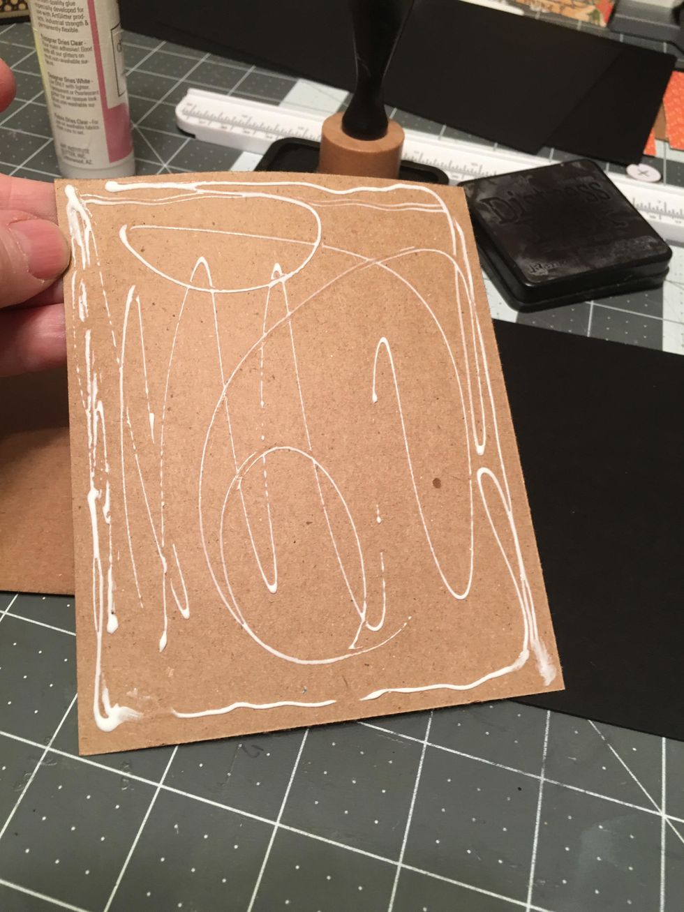 Apply glue to the back side of the kraft paper and clue to the black covers.