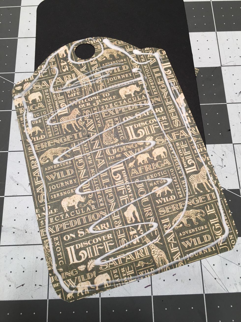 Apply glue to the back side of the paper.