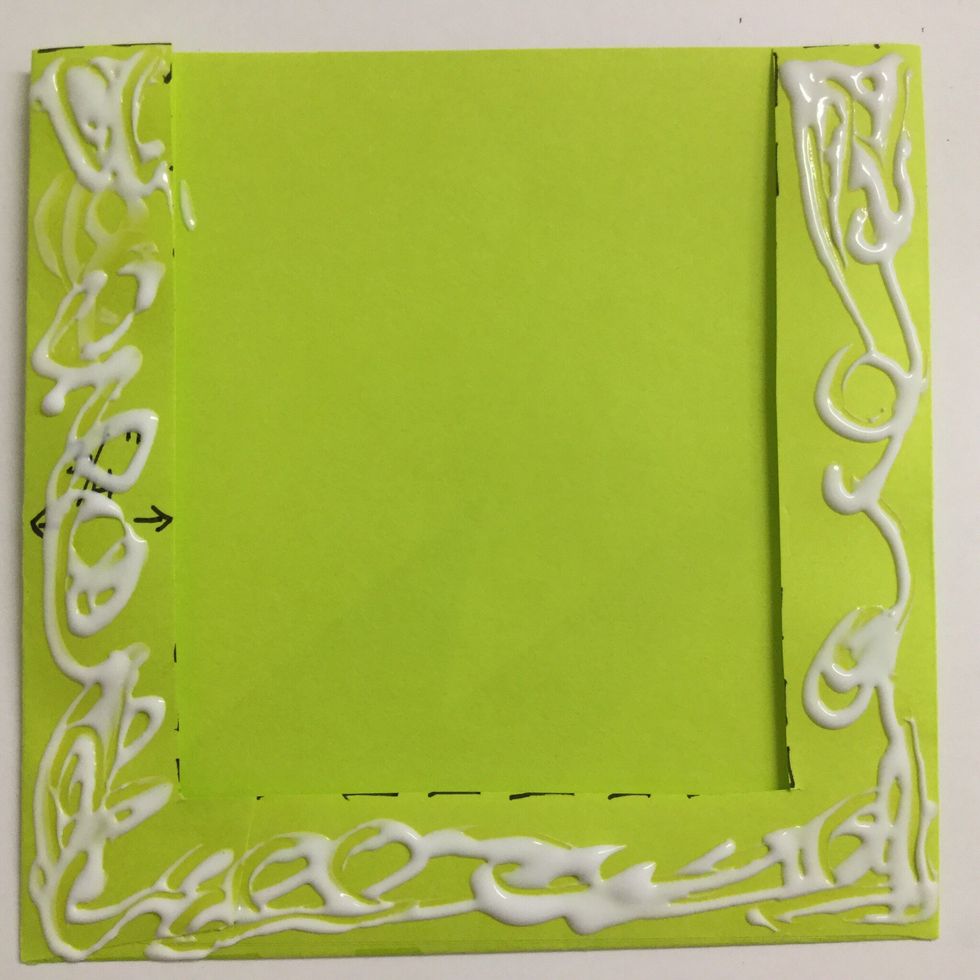Apply glue to the bottom and side borders of the envelope.