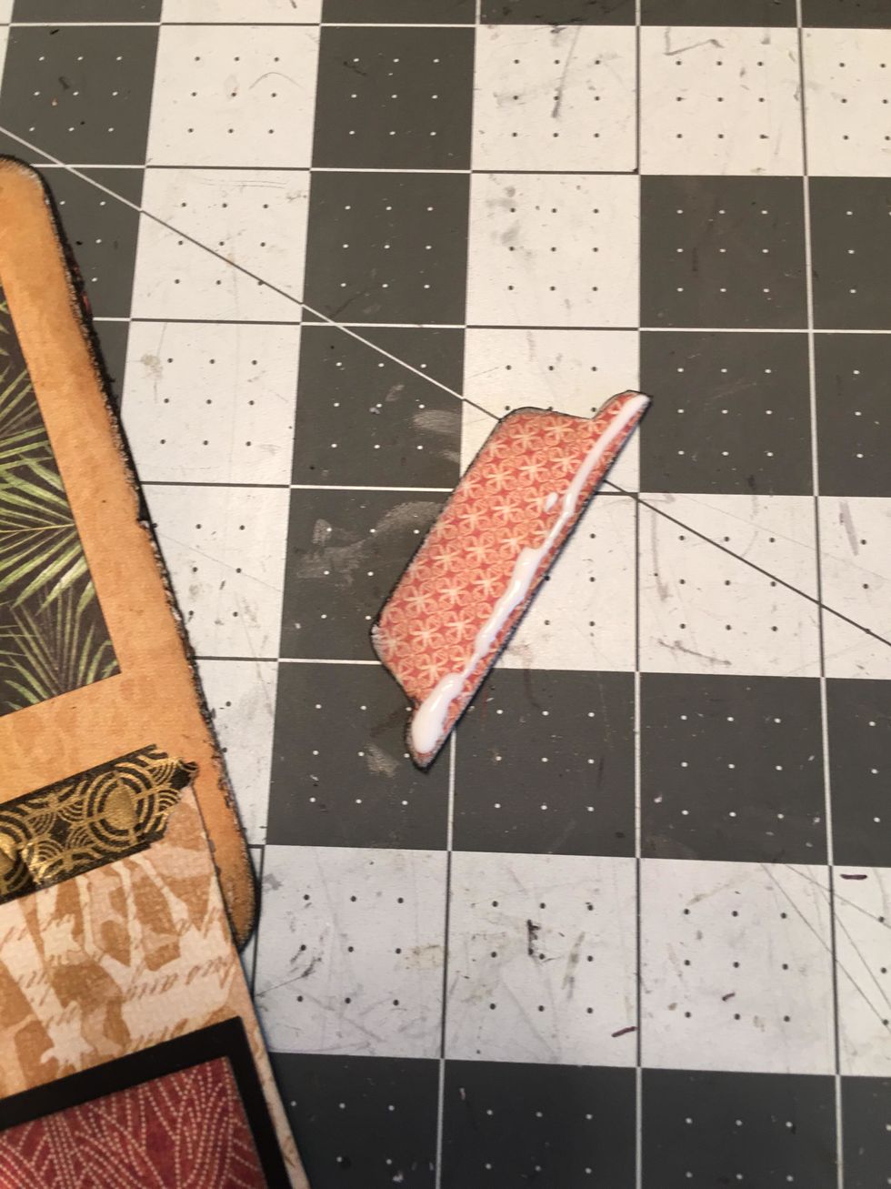 Apply glue to the bottom edge of the tab on the back side.