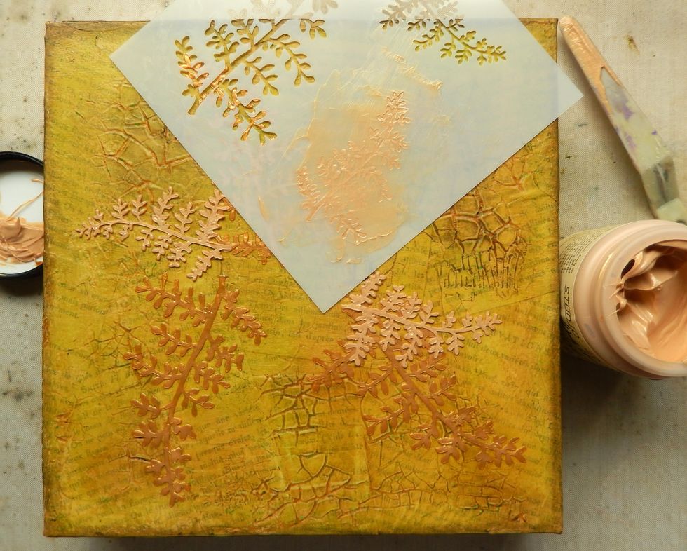 Apply Gold Embossing Paste through the Ferns stencil and allow to air dry. Repeat until you have the number of fronds you require.