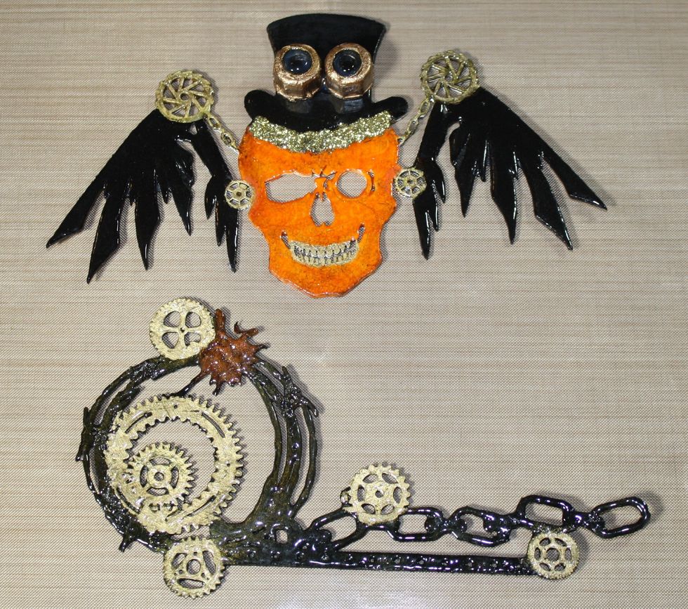 Apply heat to the UTEE, once the UTEE has melted, apply top hat Stickles Gold and steampunk goggles with Aleene's Tacky Glue