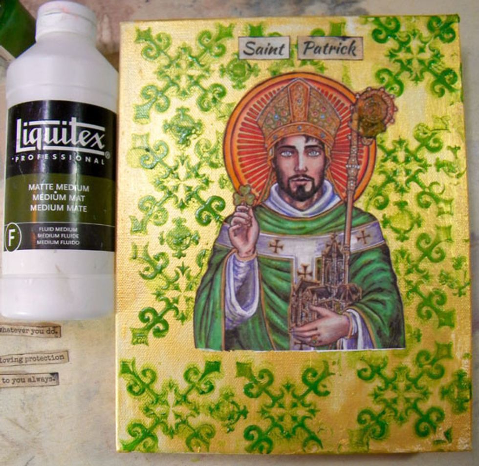 Apply matte medium to the back of the St. Patrick image and carefully glue the image to the middle of the canvas. Do this while the green is still wet so that the image will lay flat.
