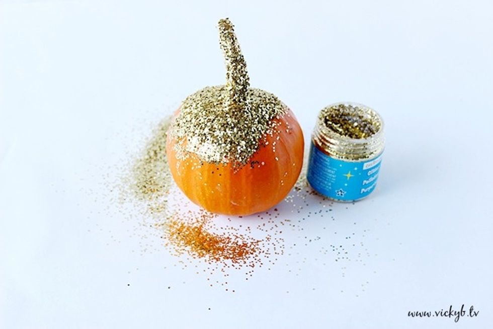 Apply Mod Podge all over the pumpkin in sections. I made the mistake of glittering the stem first, I recommend doing that last so that you can use the stem to hold and turn the pumpkin.