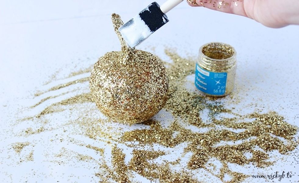 Apply Mod Podge where ever you missed a spot. I let some of the orange from the pumpkin peek through the glitter.