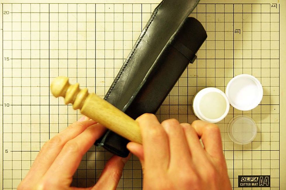 Apply oil to the leather edge and polish it with the stick of the wood.