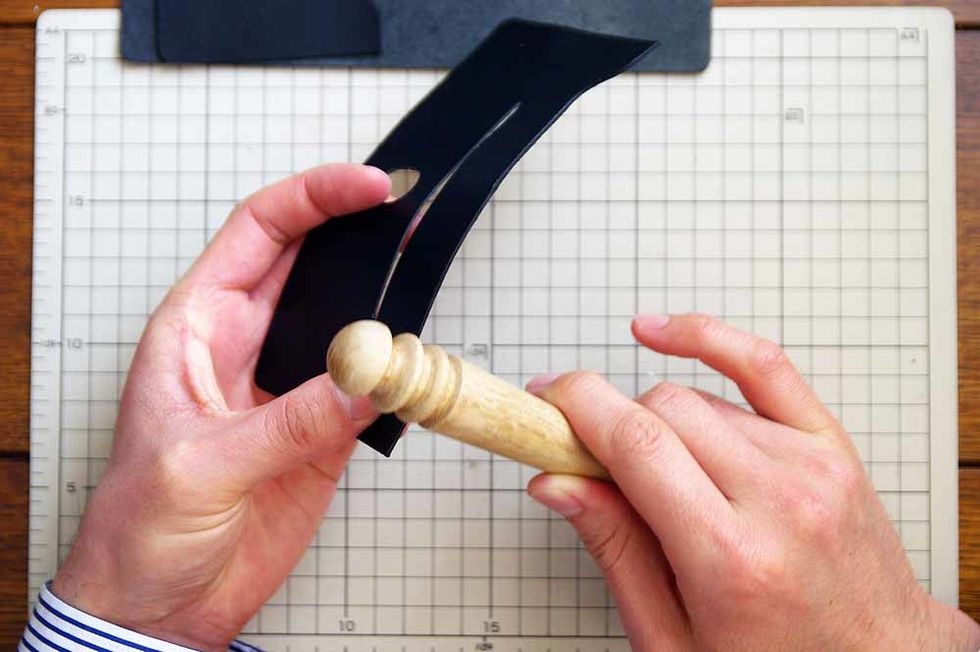 Apply oil to the leather edge and polish it with the stick of the wood.