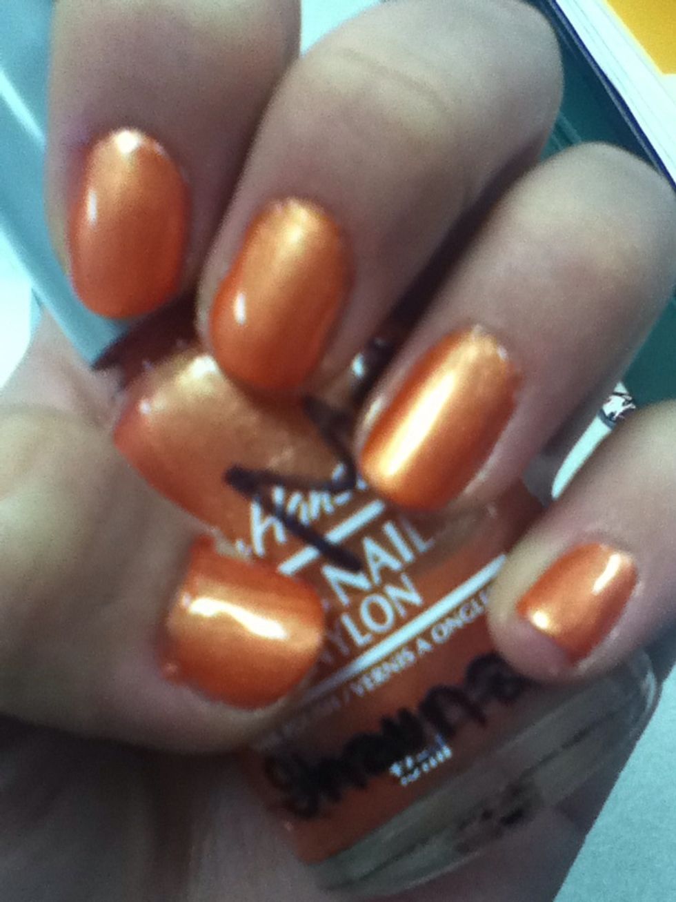 apply orange nail polish twice. dry them cperfectly.