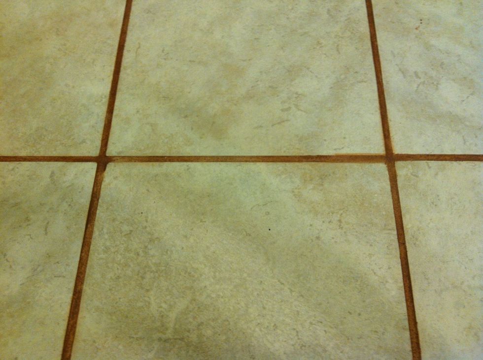 Apply paint in the grouted area only. It's okay if you color outside the lines. Use the toothbrush or scrubby to wipe off excess.