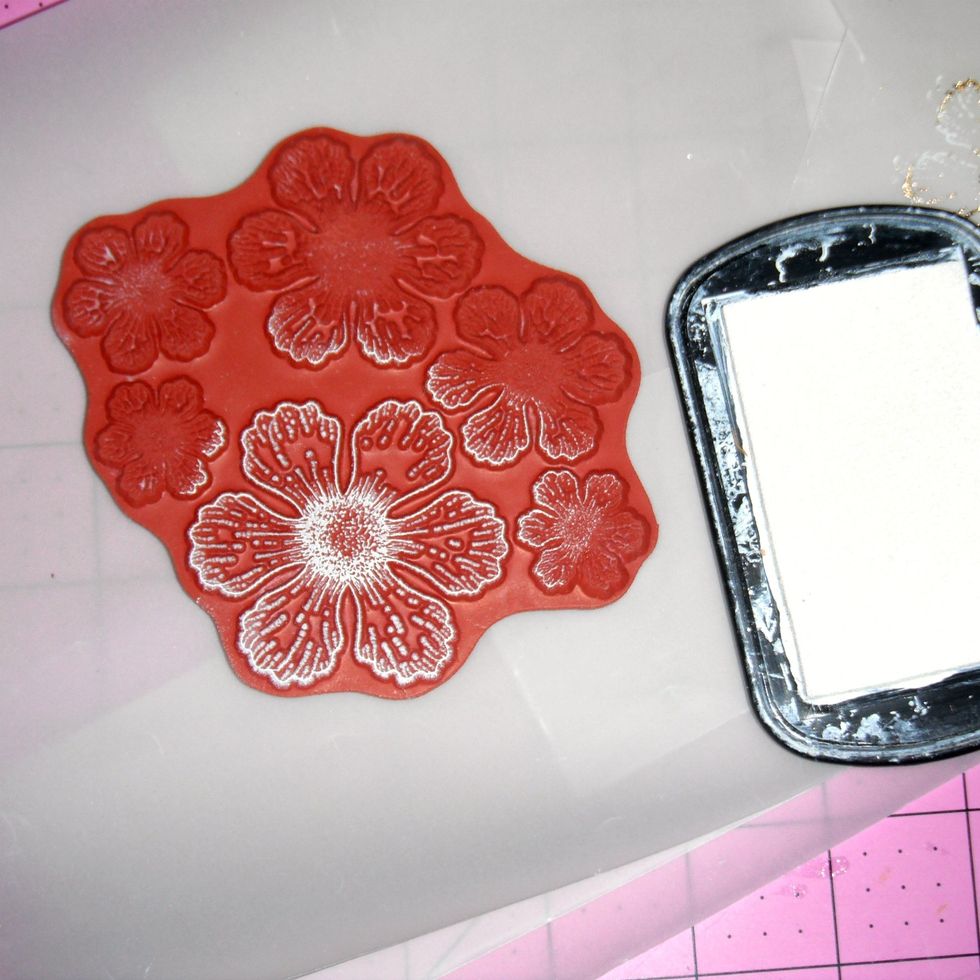Apply pigment ink onto your stamp. The color you choose will show through on spots where the foil doesn't adhere.