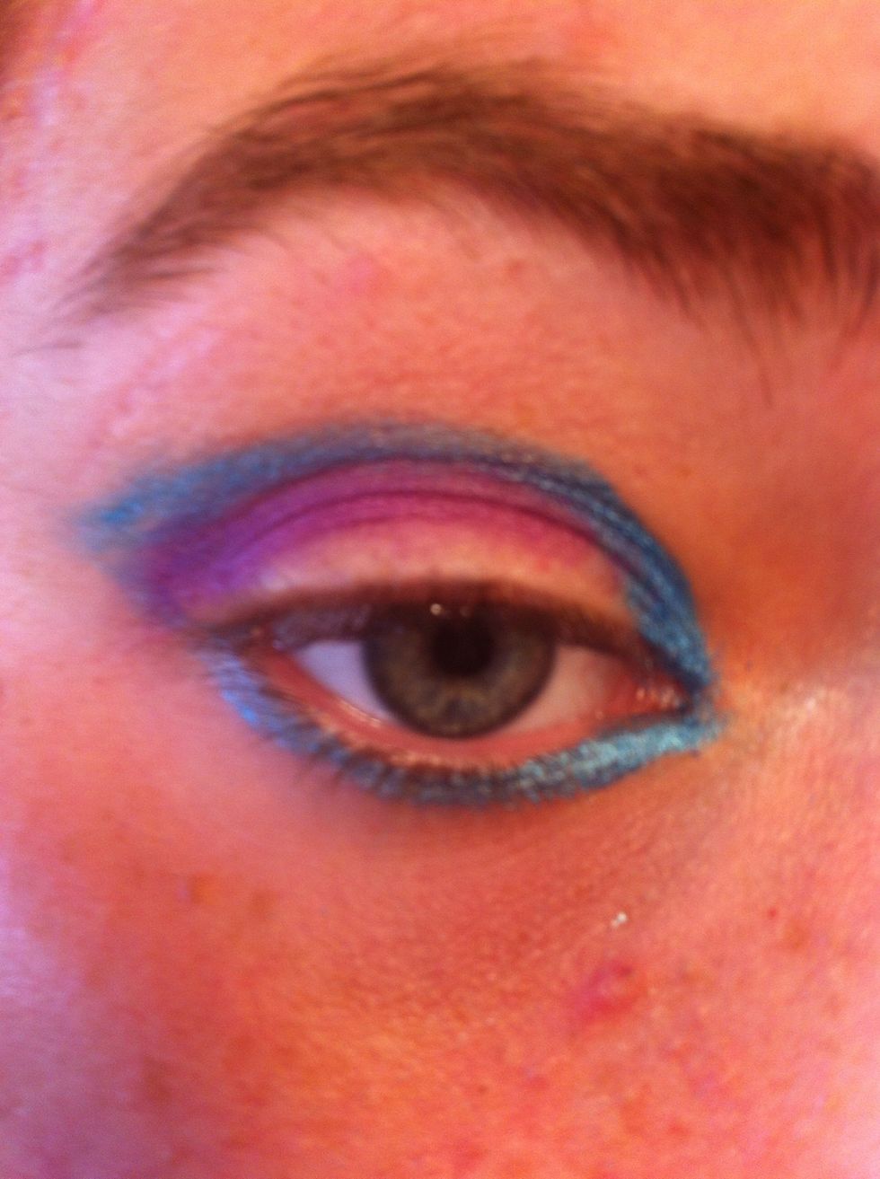 Apply purple in crease and in corner of the eye