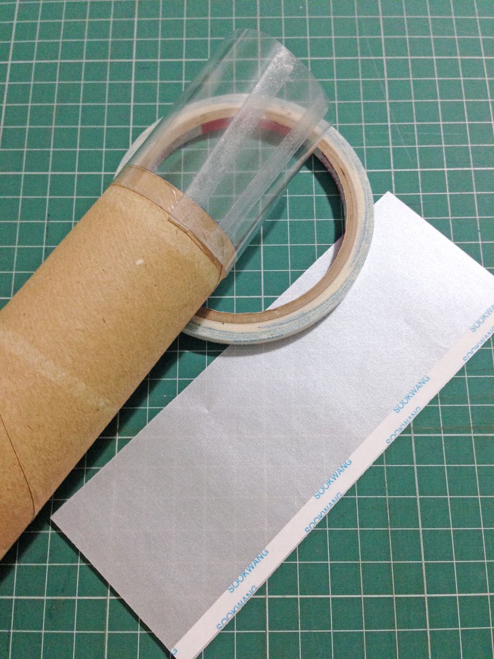 Apply scor (or double-sided) tape around one end of the kitchen roll and tape down (~0.25") the acetate sheet around the kitchen roll as shown...