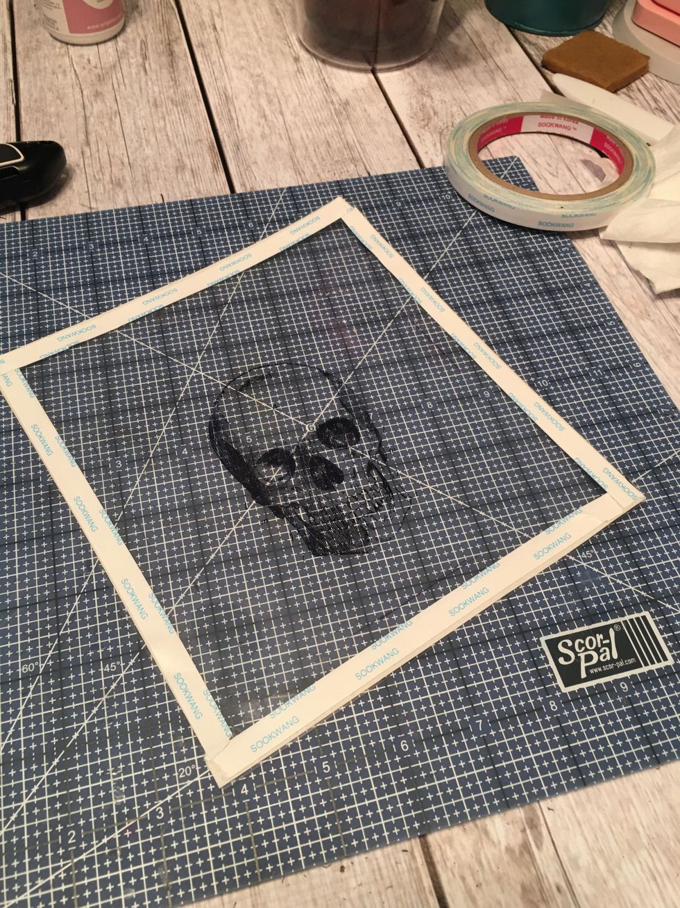 Apply scor-tape to all four sides of the transparency piece. Place tape along the edges and on the BACK side.