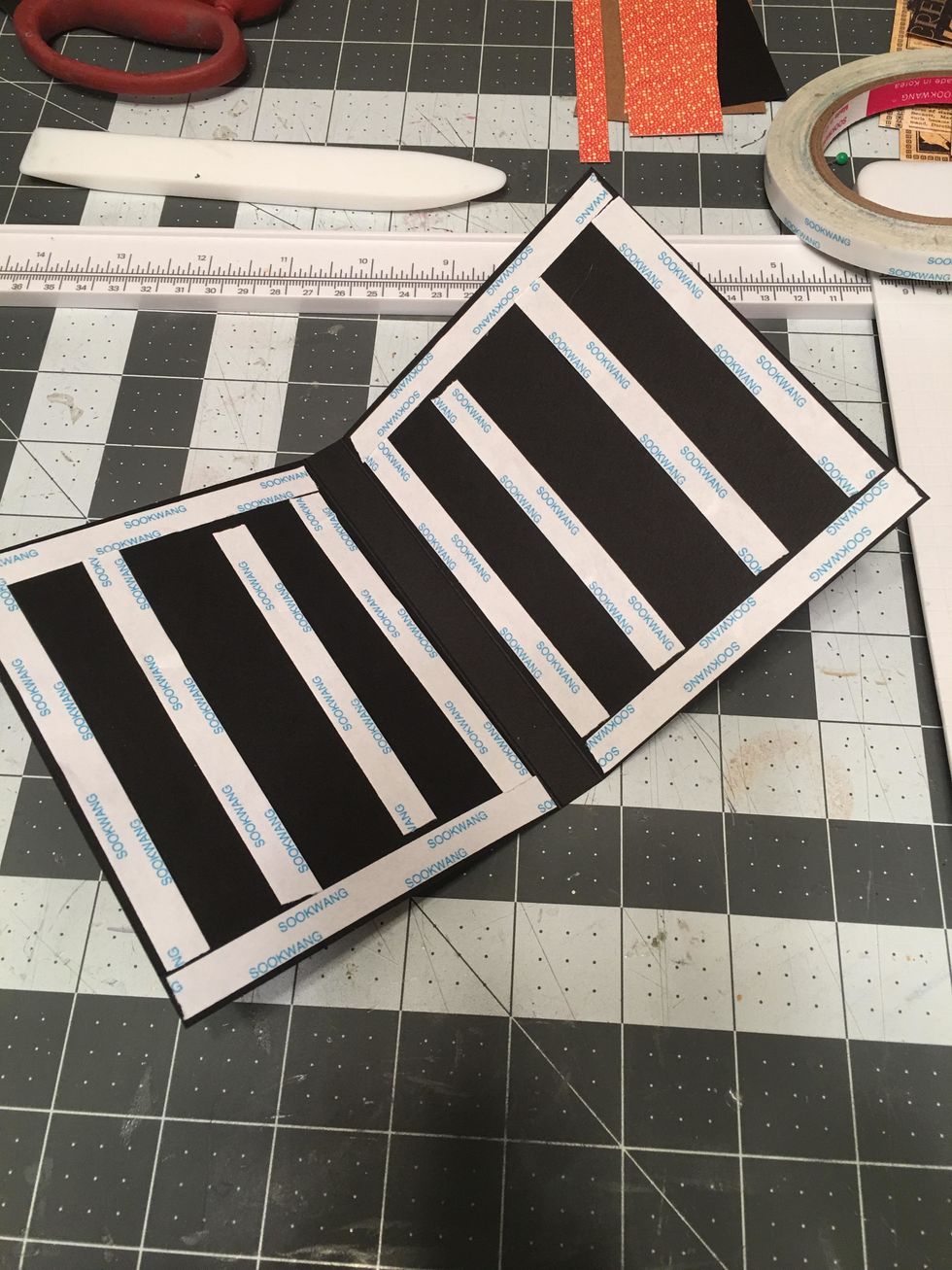 Apply scor-tape to both sides of the hinge piece. Do NOT put any tape or adhesive in the 1/2" spine area in the center.