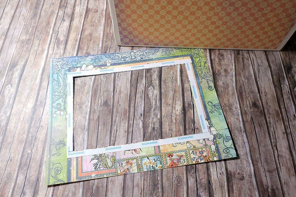 Apply scor tape to the back of the window frame, close to the cut out opening.