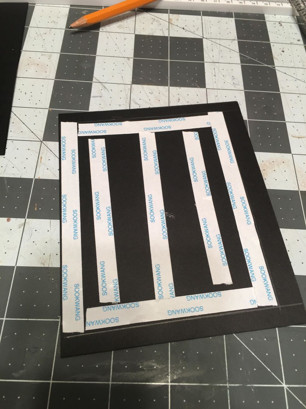 Apply scor-tape to the cover piece within the placement lines as shown.