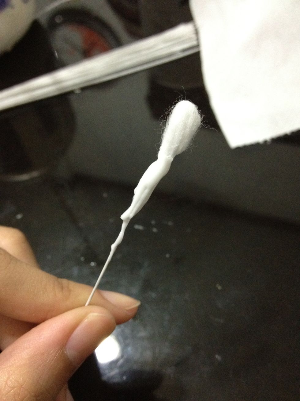 Apply some glue around the lower part of the cotton.