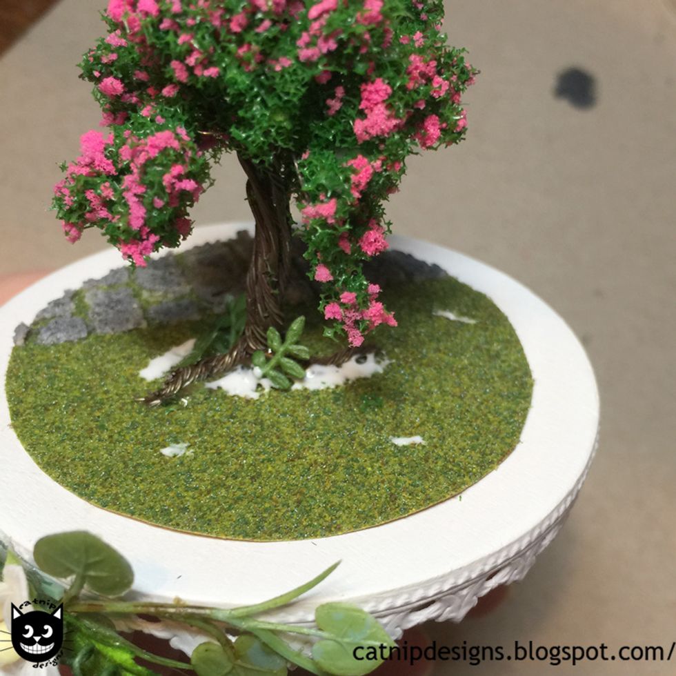 Apply some random spots of white glue to your fairy garden...