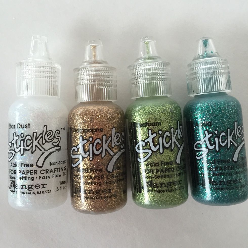 Apply Stickles to fairies. Use foam dots to adhere ovals to rectangles. Use foam dots to adhere rectangles to tags. Then, assemble and adhere fussy cut images per photos.