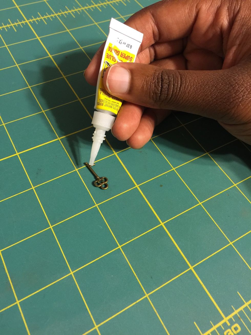 Apply super glue to one side of the key.