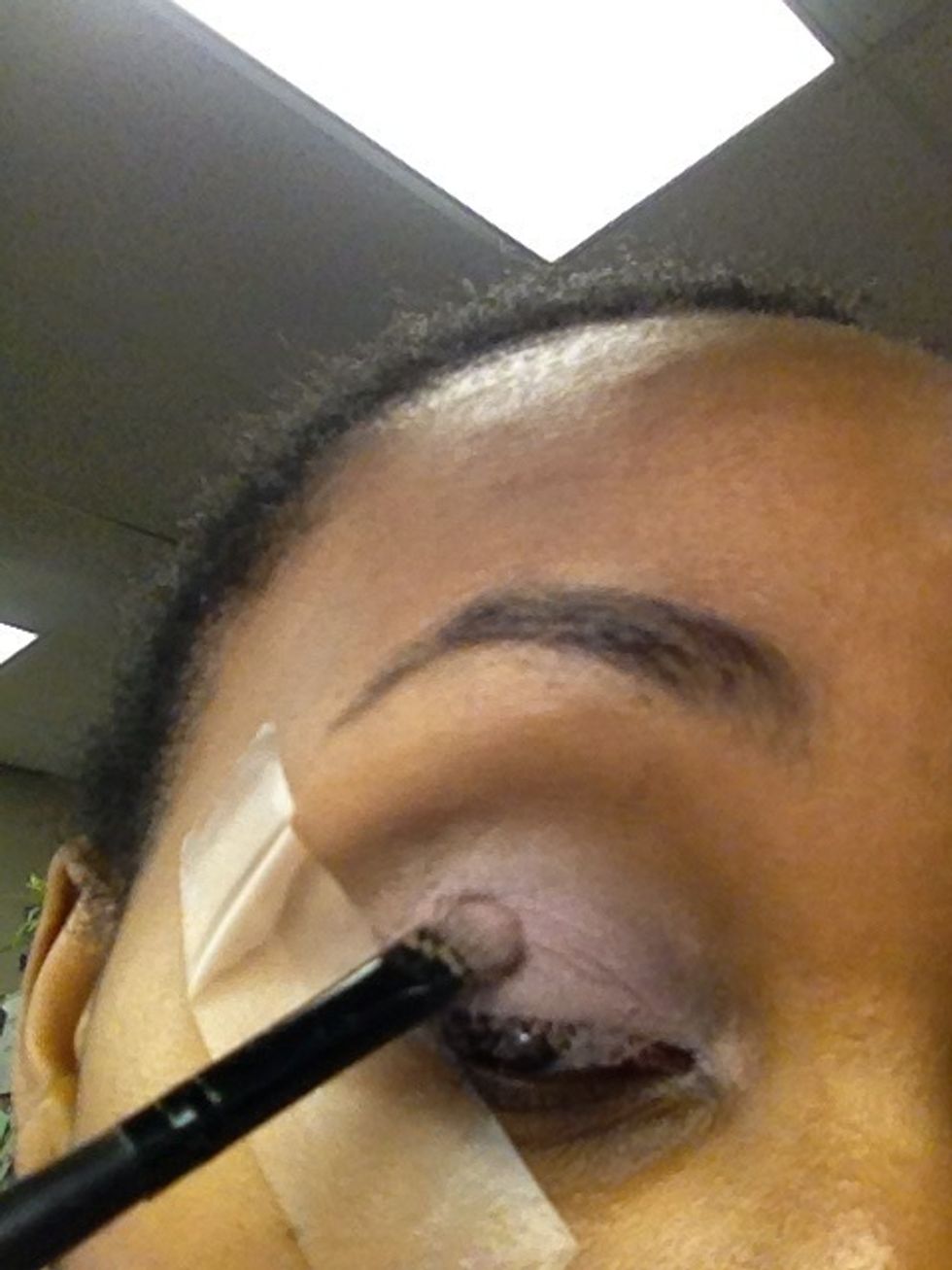 Apply tape and use a light purple or lilac eyeshadow to the lid over the NYX jumbo eye pencil that was applied