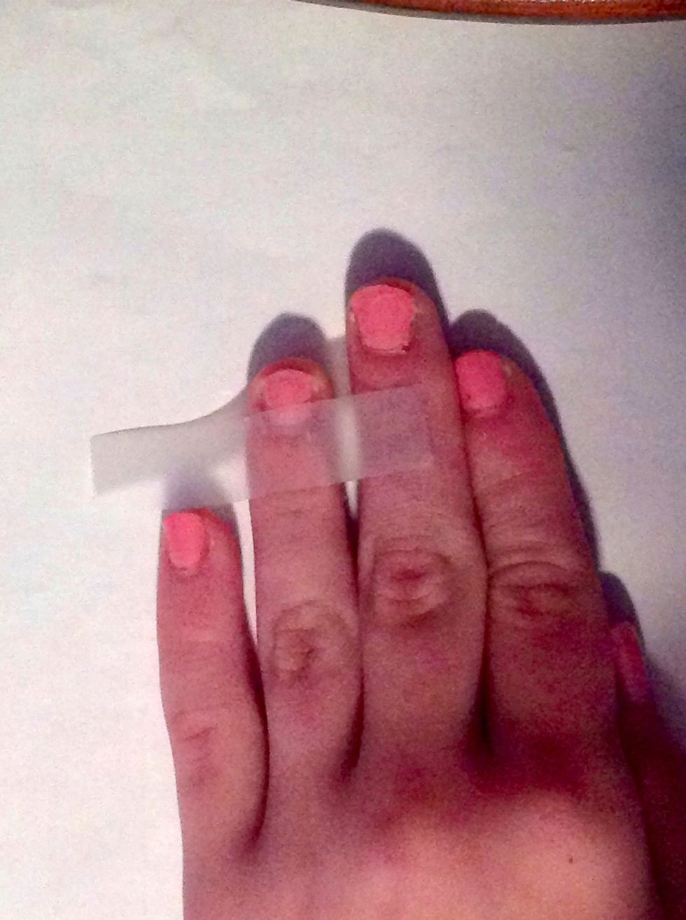Apply tape to about one third of your nail.(after first coat of nail polish is completely dry!)