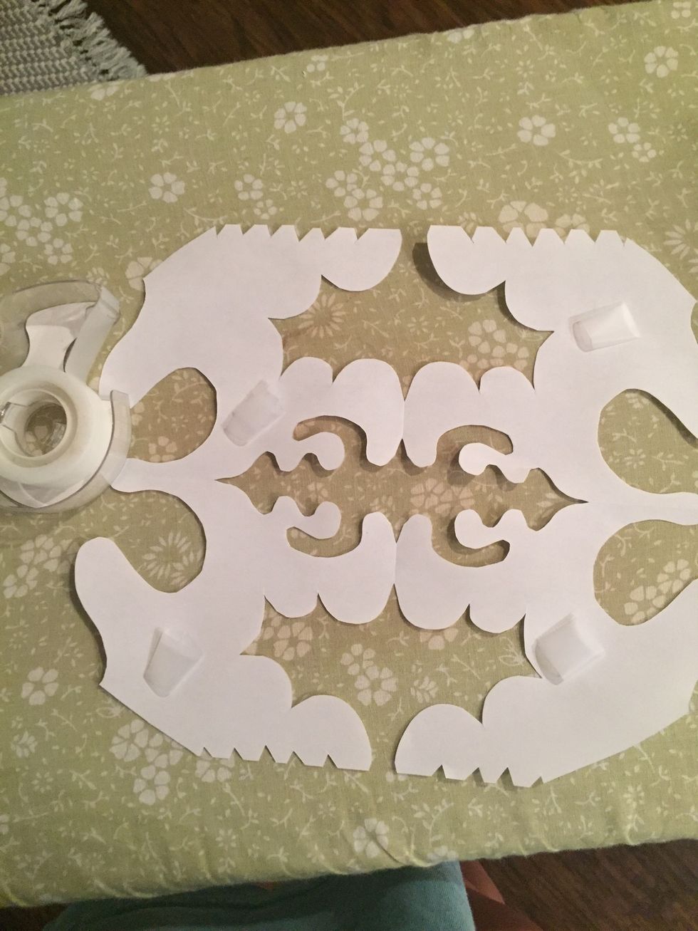 apply tape to backs of the paper design