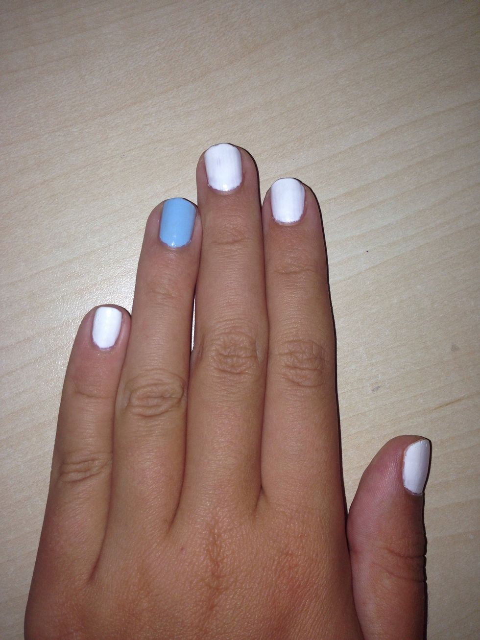 Apply the baby blue nail polish to your ring finger (2 coats)
