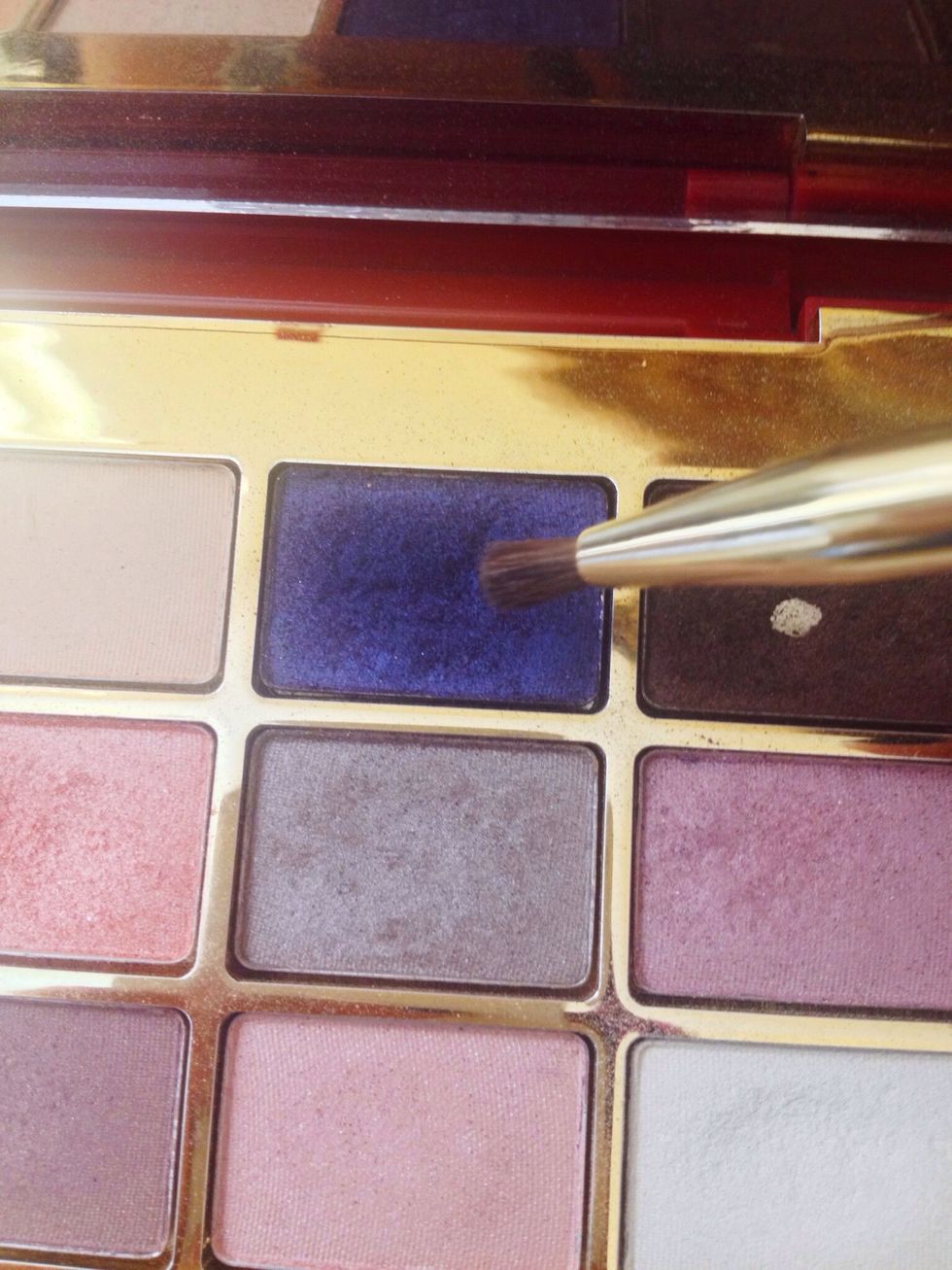 Apply the blue navy shade with a small brush in the lower lash line