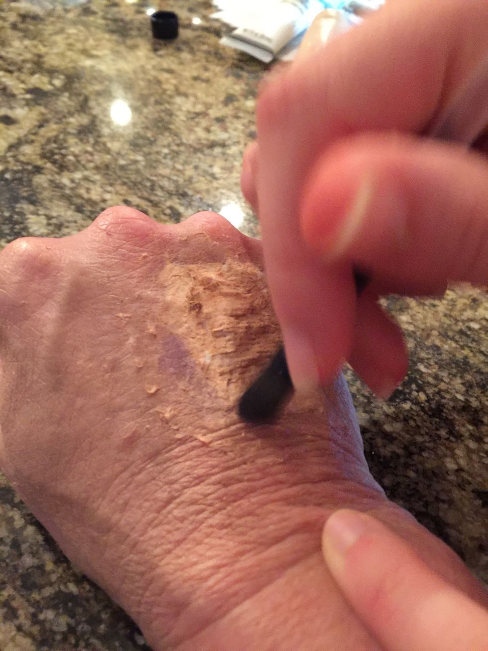 Apply the eyeshadow around your fake wound to give it a bruising effect.