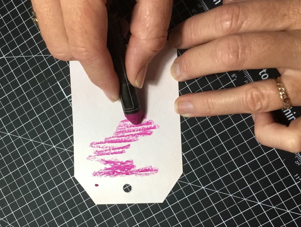 Apply the Magenta watercolour oil pastel to the backing tag as shown.