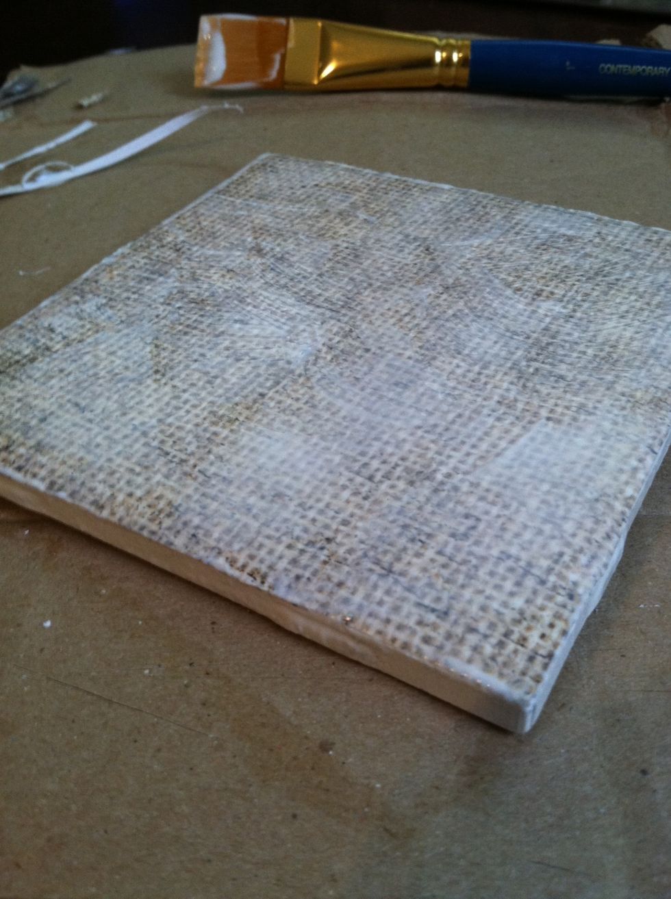 Apply the Modge Podge to the top and sides of the paper covered tile. There are multiple ways to apply Modge Podge for different effects (instructions on the bottle).