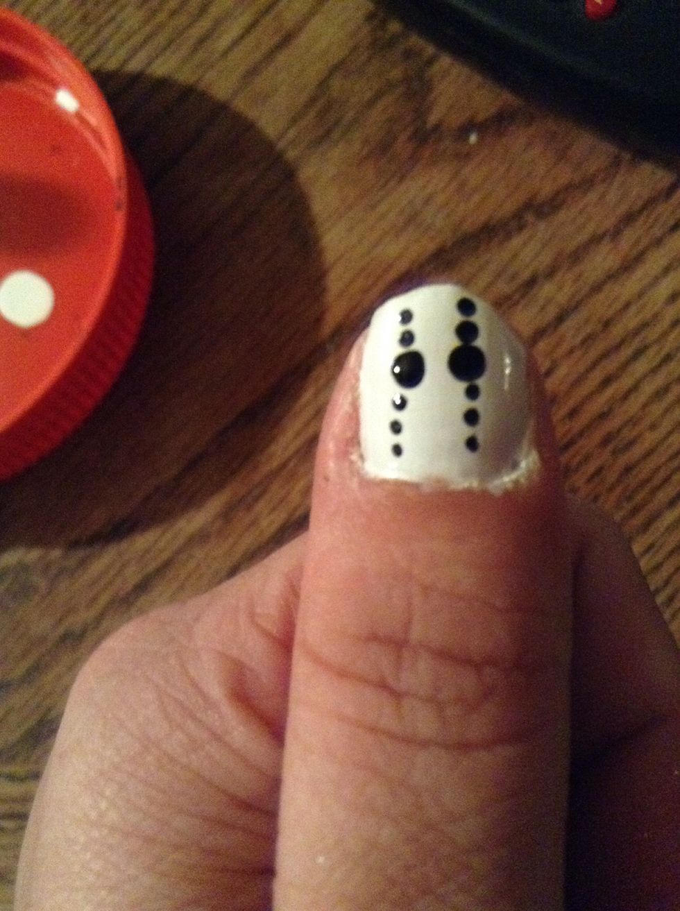 Apply three small black dots under each eyehole.