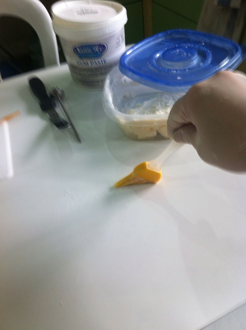 Apply top to bottom where u will knead your gum paste. If your gum paste becomes to sticky apply a bit of powdered sugar.:)