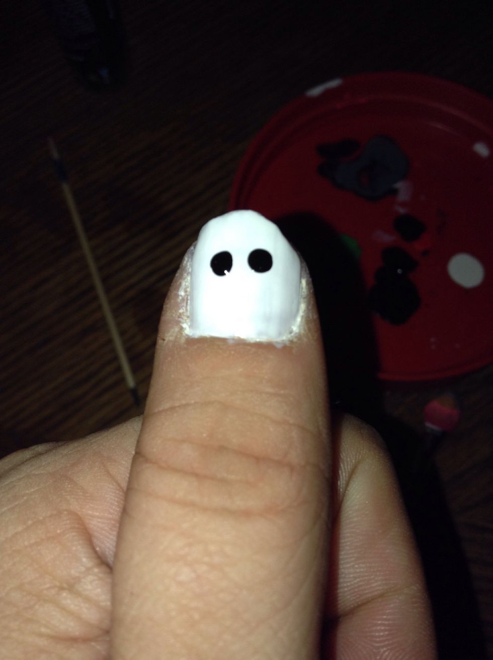 Apply two bigger dots of black nail polish for the eyes of the mask. I used an old peanut butter jar lid to put a small amount of polish in to make this easier.