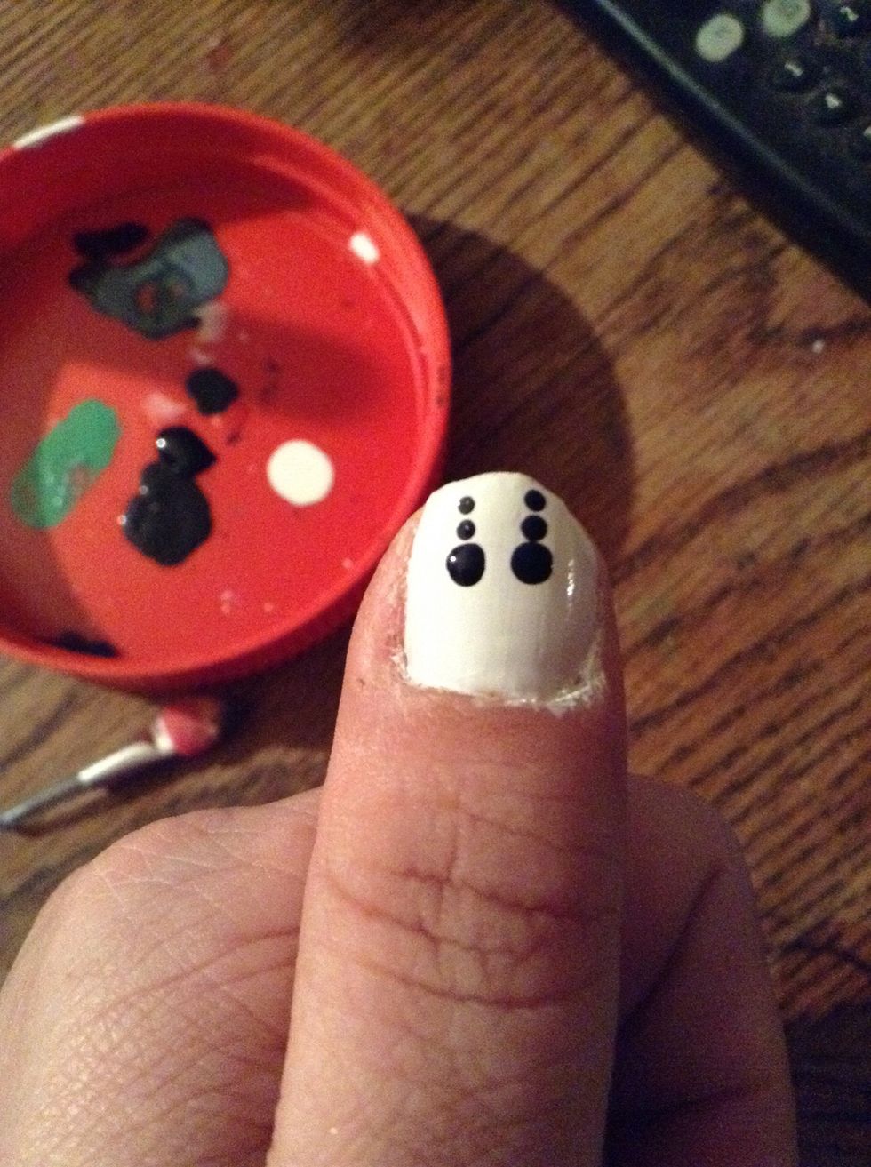 Apply two smaller black dots over each eyehole.