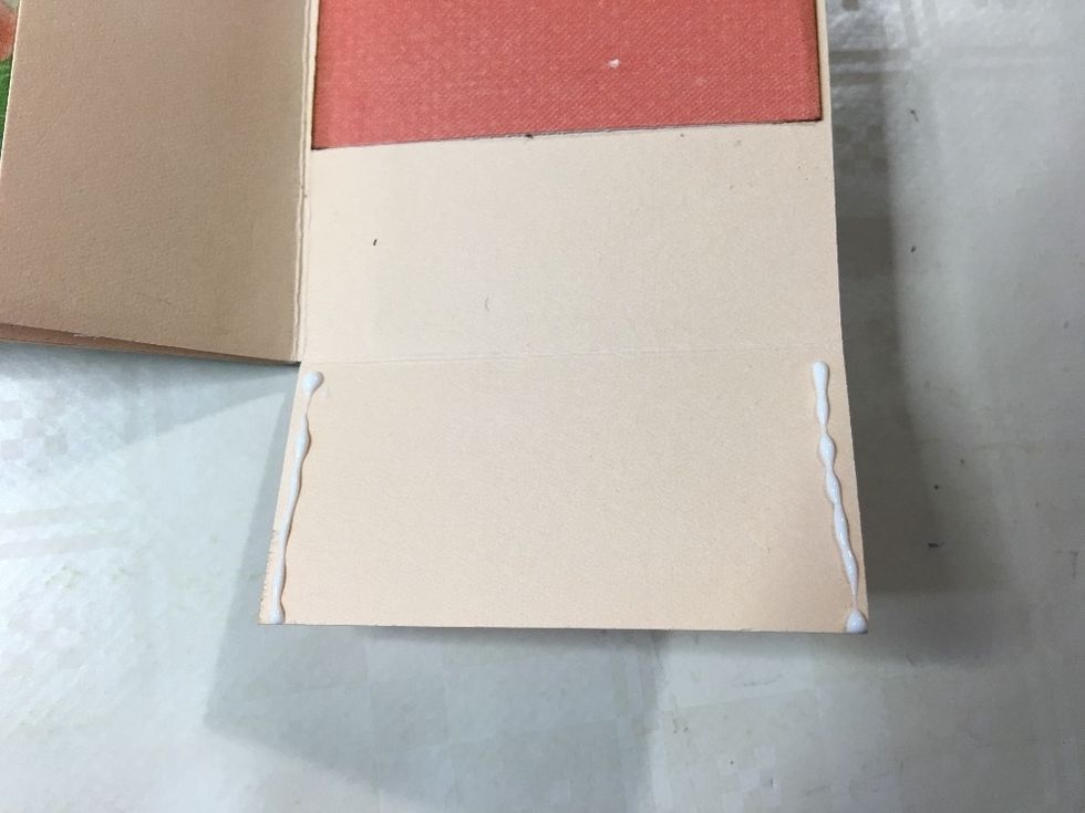 Apply wet glue to both side edges of the bottom flap, as shown.